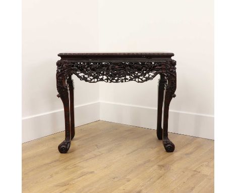 A Chinese hardwood table,late Qing dynasty, the rectangular top supported on four 'S' shaped legs with scroll feet, the apron