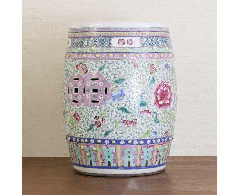 A Chinese famille rose garden seat,early 20th century, of drum form, decorated with pierced coins amongst scrolling flowers  