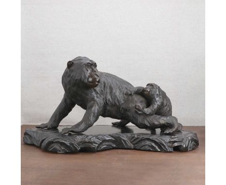 A Japanese bronze okimono, Meiji period (1868-1912), naturalistically cast with a monkey crawling on all fours, its head slig