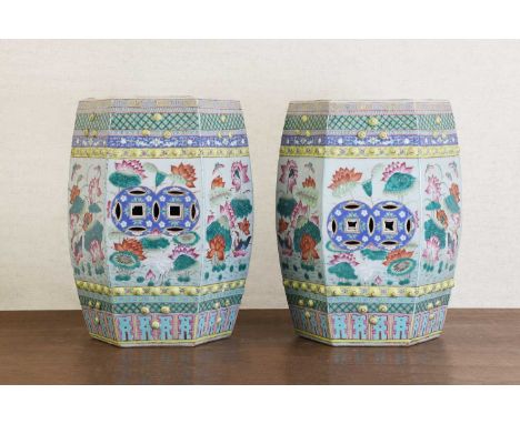 A pair of Chinese famille rose garden seats, early 20th century, each of hexagonal form, decorated with pierced coins amongst