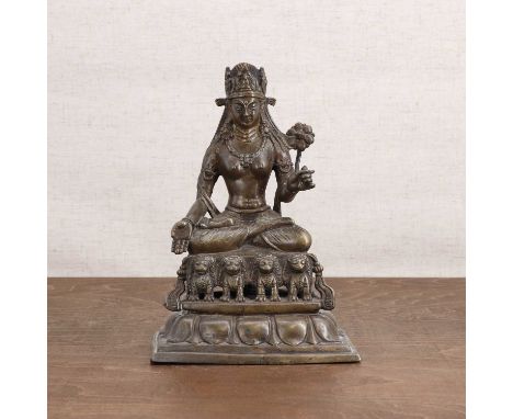 A Tibetan bronze bodhisattva, wearing beaded jewellery and a lower garment, seated crossed-legged in Varada mudra with a flow