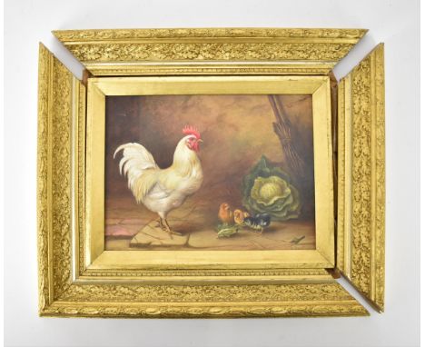 Edgar Hunt (1876-1953) Britishdepicting a barn interior with a rooster and chick eating a cabbage leaf, signed lower right 'E