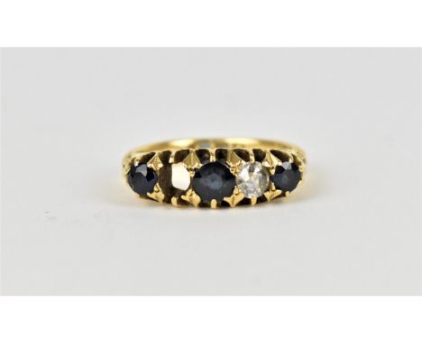 An 18ct yellow gold, sapphire and diamond five stone dress ring, with graduated stones, the central sapphire 0.4mm diameter, 