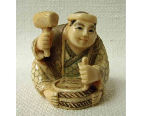 A Japanese ivory Netsuke, late 19th/early 20th century, a seated wood carver, signed to underside, 3.5cm high