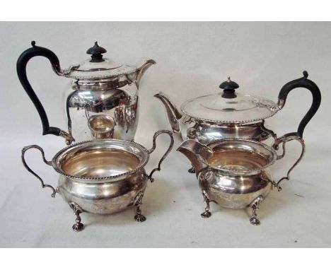 An early 20th century silver four-piece tea service of circular form with gadrooned rim, each piece supported on four shell f