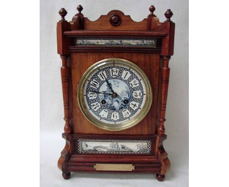 A 19th century walnut mantel clock, architectural style with Delft face, Arabic numerals, conforming rectangular Delft panels