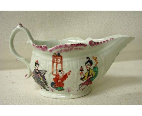 An early 19th century creamware sauce boat of typical form with wavy rim, elongated spout and S scroll handle, polychrome dec