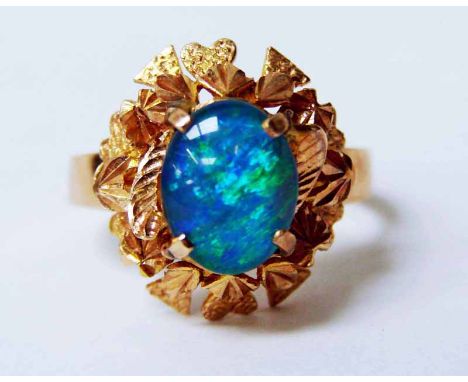 A modern 9ct gold and opal ring, the single oval stone measures 9mm by 7mm in a foliate setting, ring size Q, total weight 5.