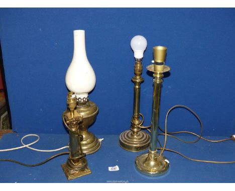 Three brass table lamps and an oil lamp converted to electric.