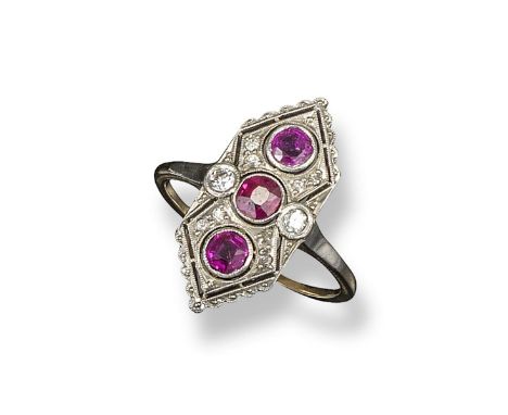 An early 20th century ruby and diamond lozenge-shaped ring, the elongated hexagonal-form ring is millegrain-set with three cu