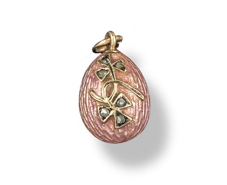 A small gold egg pendant, with pink guilloche enamel decoration and applied with foliate decoration set with rose cut diamond