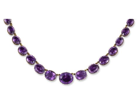A Victorian amethyst rivière necklace, the graduated oval-shaped amethysts are set in gold coronet mounts. 41cm long.