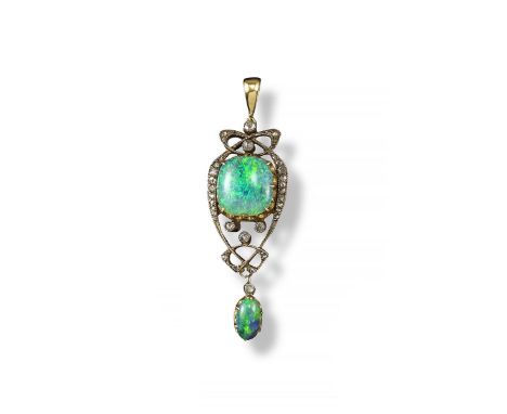 An Art Nouveau opal and diamond pendant, the solid white opal cabochon is set within scrolling diamond-set surround in platin