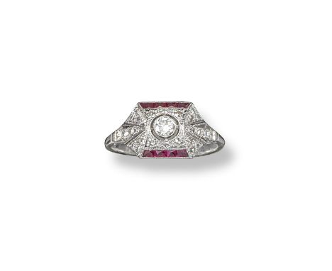 A diamond and ruby cluster ring, the centre round brilliant cut diamond is set within a surround of smaller diamonds and two 