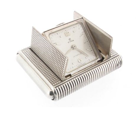 A silver folding travel clock by Cyma, the terminals compress to open the front panel and reveal the watch face. The signed s