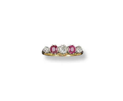 A ruby and diamond five stone ring, set with graduated rubies and diamonds in platinum and yellow gold. Size N.