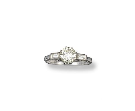 A diamond solitaire ring, the circular-cut diamond weighs approximately 1.10cts, set with a baguette-shaped diamond to each s