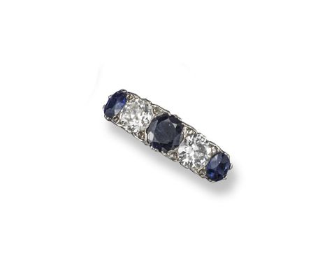 A sapphire and diamond five stone ring, alternately set with sapphires and old circular-cut diamonds in platinum and gold. Si