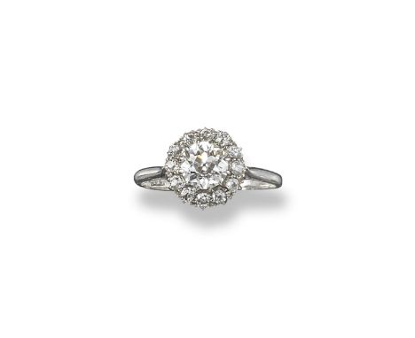 A diamond cluster ring, the central circular cut diamond weighs approximately 1.00cts and is set within a surround of smaller