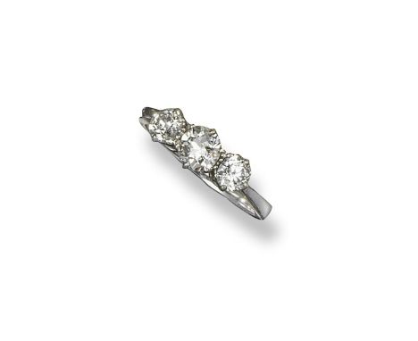 A diamond three stone ring, the three graduated old circular-cut diamonds are set in platinum. Size N.