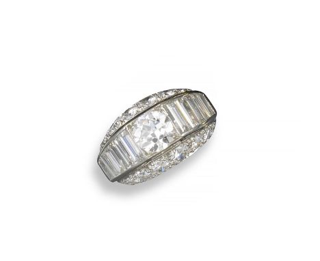 A bombe-shaped diamond dress ring by Van Cleef & Arpels, set with a circular-cut diamond within a line of graduated baguette-