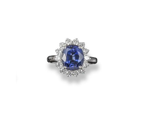 A sapphire and diamond cluster ring, the oval-shaped sapphire is set within a surround of circular cut diamonds in white gold