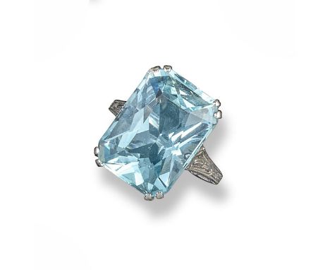 An aquamarine ring, the rectangular-cut aquamarine is set in carved and pierced white gold mount. With inner re-sizing balls.