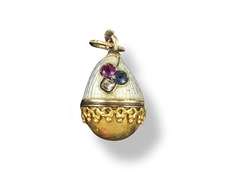 A small gold egg pendant by Fabergé, the upper section with oyster coloured guilloche enamel decoration and set with a small 