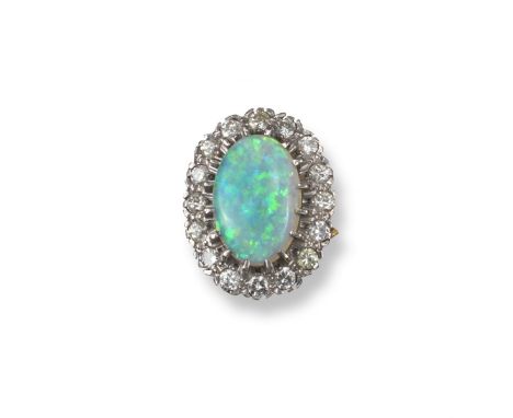 An opal and diamond cluster ring, the oval-shaped white opal is set within a surround of circular-cut diamonds in platinum an