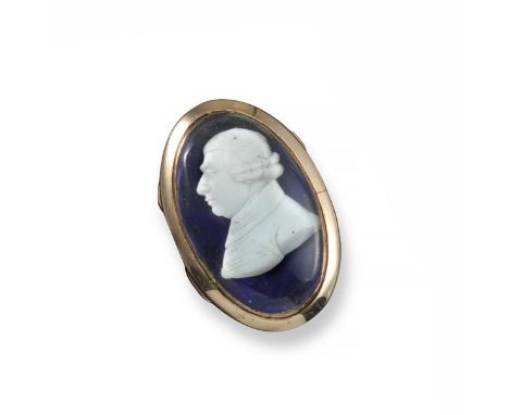 An early 19th century gold ring, applied with a Tassie cameo of a gentleman on blue guilloche enamel ground. Closed back gold