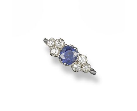 A sapphire and diamond half hoop ring, set with a cushion-shaped sapphire within six circular-cut diamonds in platinum. Size 