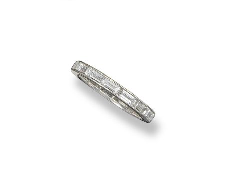 A diamond full circle eternity ring, the fifteen baguette-shaped diamonds channel-set in platinum. Size K 1/2.