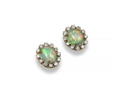 A pair of opal and diamond cluster earrings, the solid white opal cabochons are set within a surround of small circular diamo