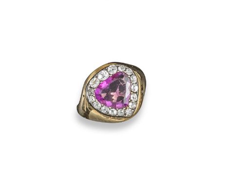 A Burmese sapphire and diamond cluster ring, the triangular pear-shaped pink sapphire is set within a surround of old cushion