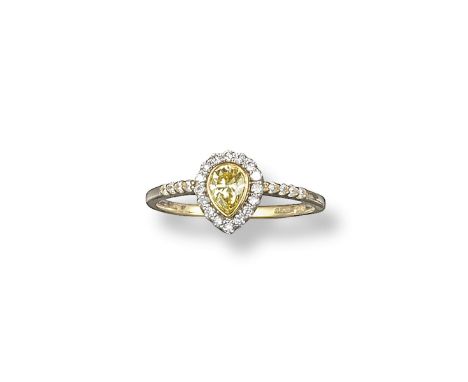 A yellow and white diamond cluster ring, the pear shaped yellow diamond is set within a surround of circular-cut white diamon