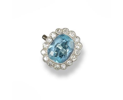 An aquamarine and diamond ring, the oval-shaped aquamarine is set within a surround of circular-cut diamonds in platinum and 