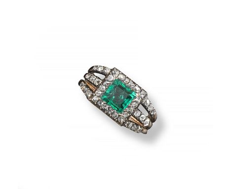 A George III emerald and diamond cluster ring, the square-shaped emerald is set within a surround of cushion shaped diamonds 