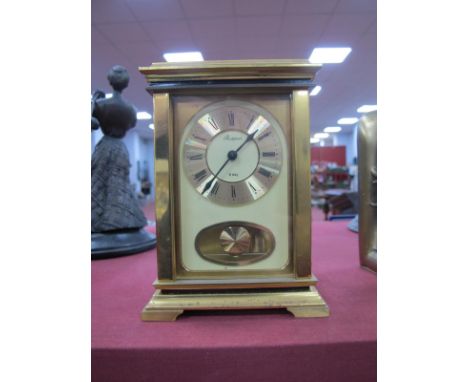 Rapport Eight Day Mantle Clock, with oval pendulum aperture in heavy brass case, 15cm high, 11cm wide.