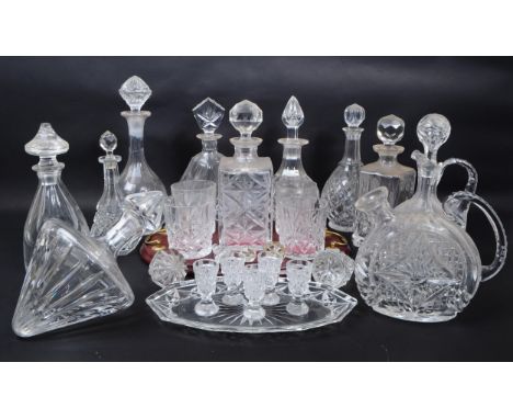 Large collection of vintage 20th century cut glass crystal decanters, some with stoppers and jugs.