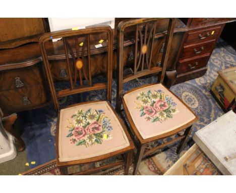 A pair of Edwardian inlaid mahogany bedroom chairs, the seats upholstered  in floral tapestry