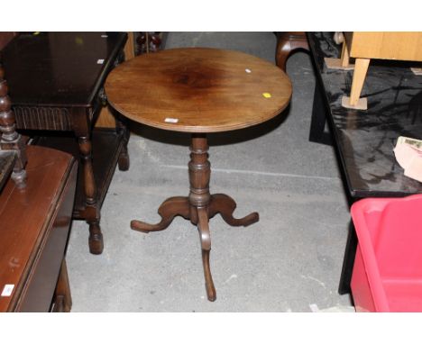 A Georgian style mahogany tripod table raised on turned collumn