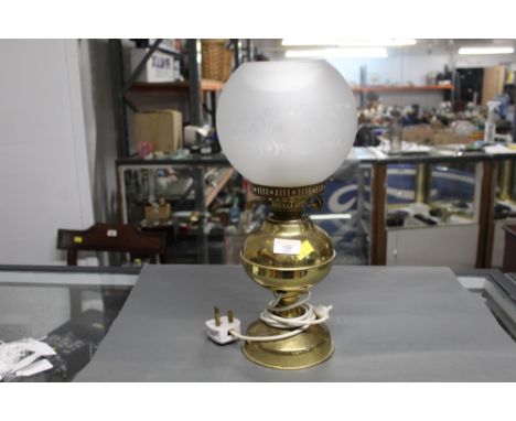 A brass effect electric table lamp in a form of an oil lamp 