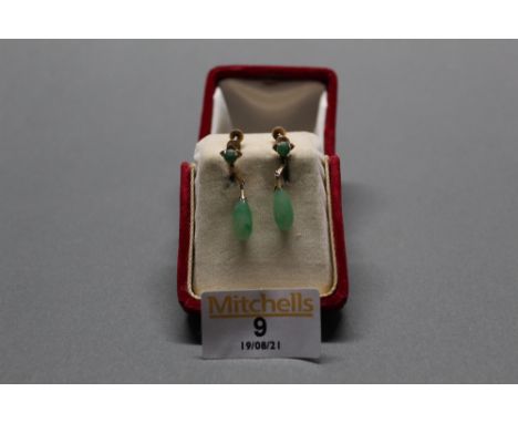 A pair of 14k gold and jade earrings (screw back clasp) gross weight 4.1 grams