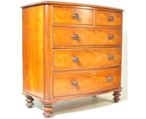 A 19th century Victorian bow front mahogany chest of drawers having a flared top, over a bank of two over three drawers raise