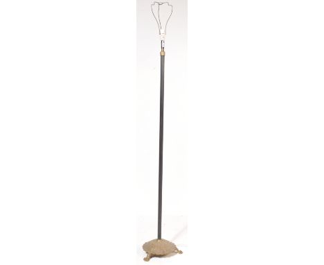 A mid 20th century floor standing ebonised metal standard lamp with round moulded base with paw feet. Measures 143cm tall.
