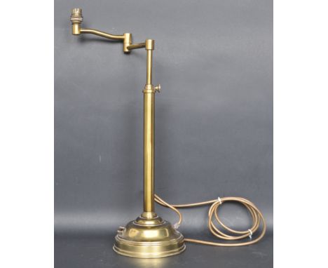 A vintage 20th century brass table lamp. The lamp having an articulate arm to the top, cylindrical telescopic column raised o