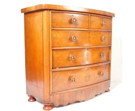 A 19th century Victorian mahogany bow front chest of drawers having a bank of two over three drawers with turned handles rais