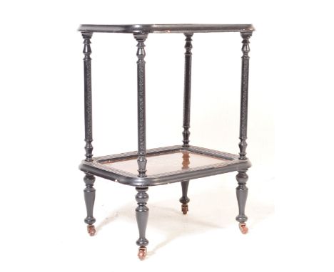A 19th century Victorian two tier butlers serving trolley. The mahogany glass lined tiers set to an ebonised walnut turned co