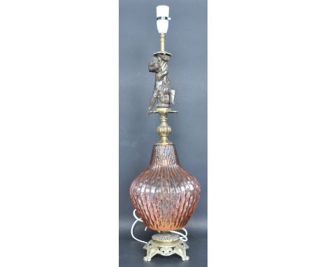 A 20th century brass and peach glass table lamp having a pierced base, ridged ovoid shaped body and spelter putti above. Meas