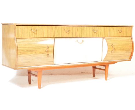 A vintage retro mid 20th century melamine / formica sideboard credenza. The sideboard of a long rectangular form having four 